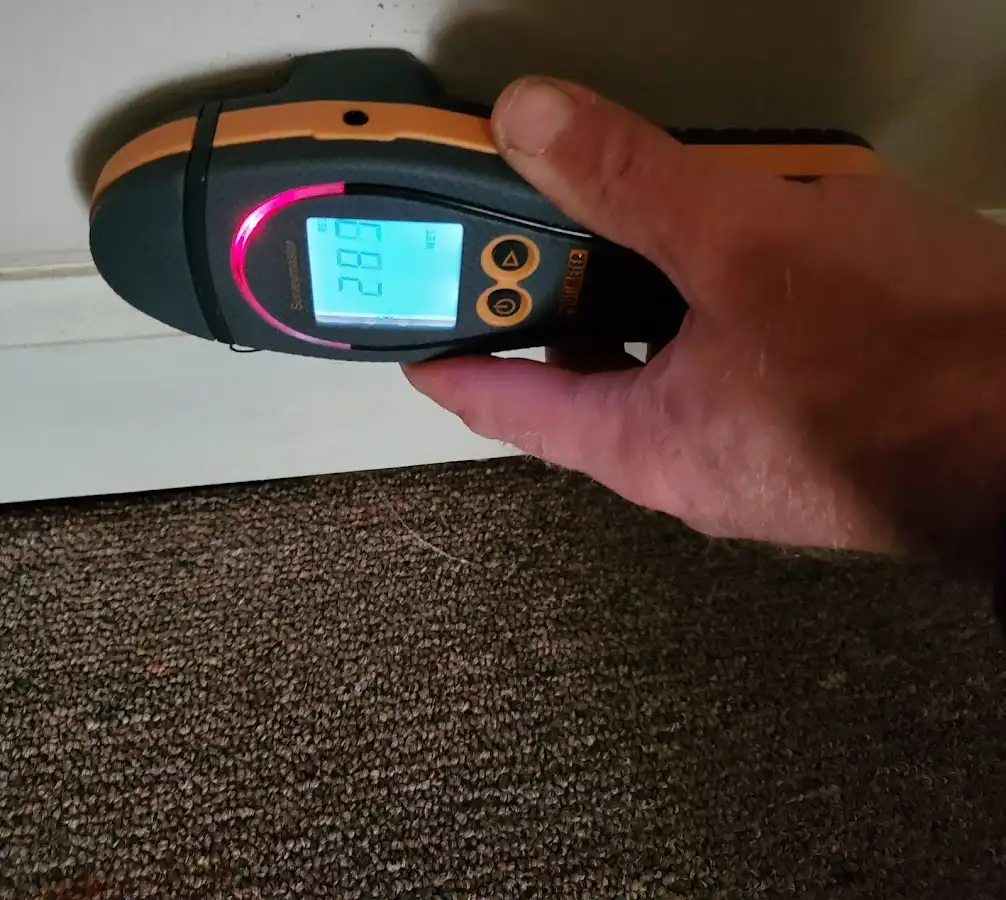 Moisture detection at baseboard during Storm Damage Restoration in Pikesville